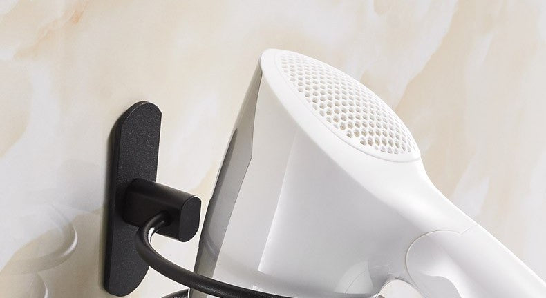 Wall-mounted hair dryer holder by Glow Ritual