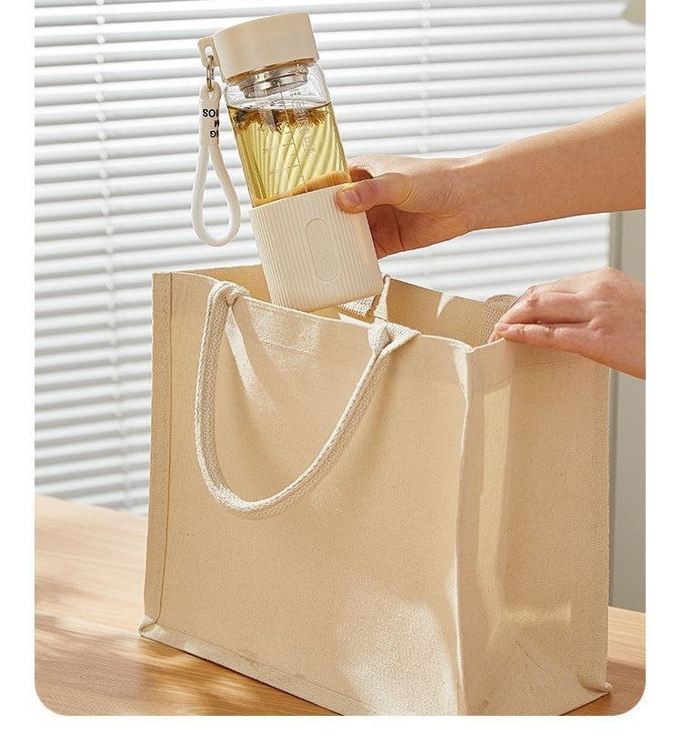Glass water bottle with silicone sleeve by Glow Ritual