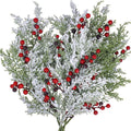 Artificial cedar and red berry picks by Glow Ritual