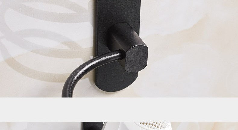 Wall-mounted hair dryer holder by Glow Ritual
