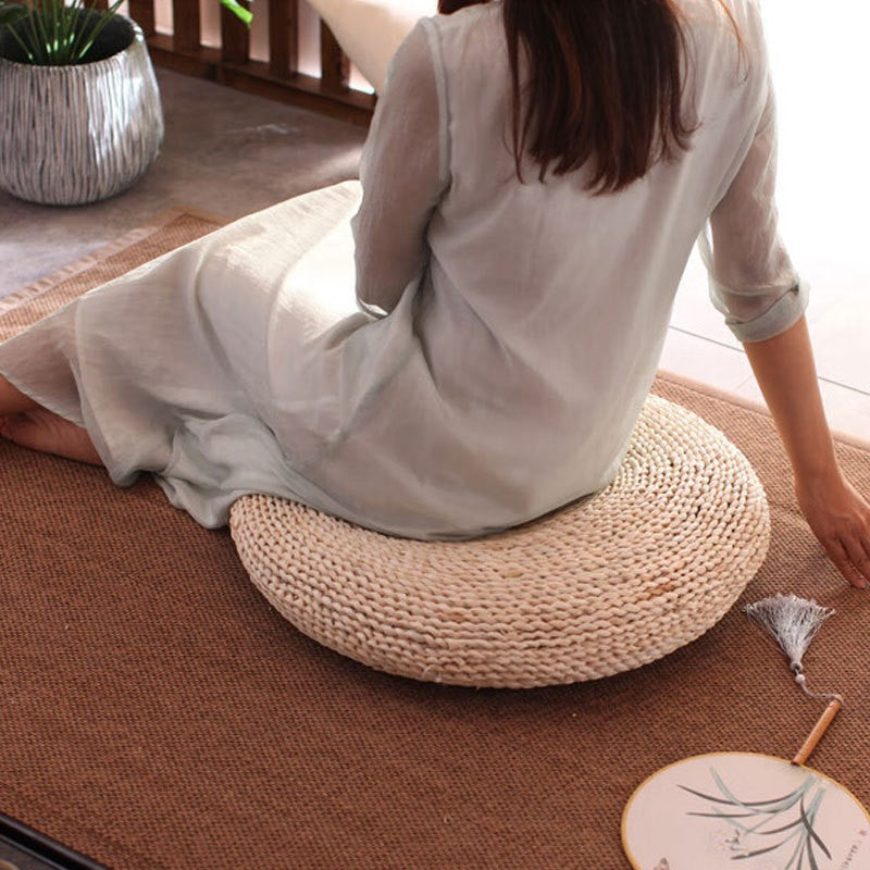 Woven straw meditation cushion by Glow Ritual